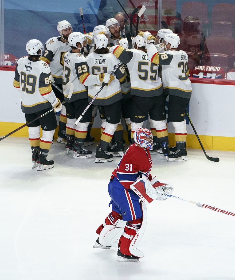 Montreal Canadiens goaltender Carey Price skates off the ice as members of the Vegas Golden Knights celebrate a goal by Nicolas Roy during overtimeof Game 4 in an NHL Stanley Cup playoff hockey semifinal in Montreal, Sunday, June 20, 2021. (Paul Chiasson/The Canadian Press via AP)