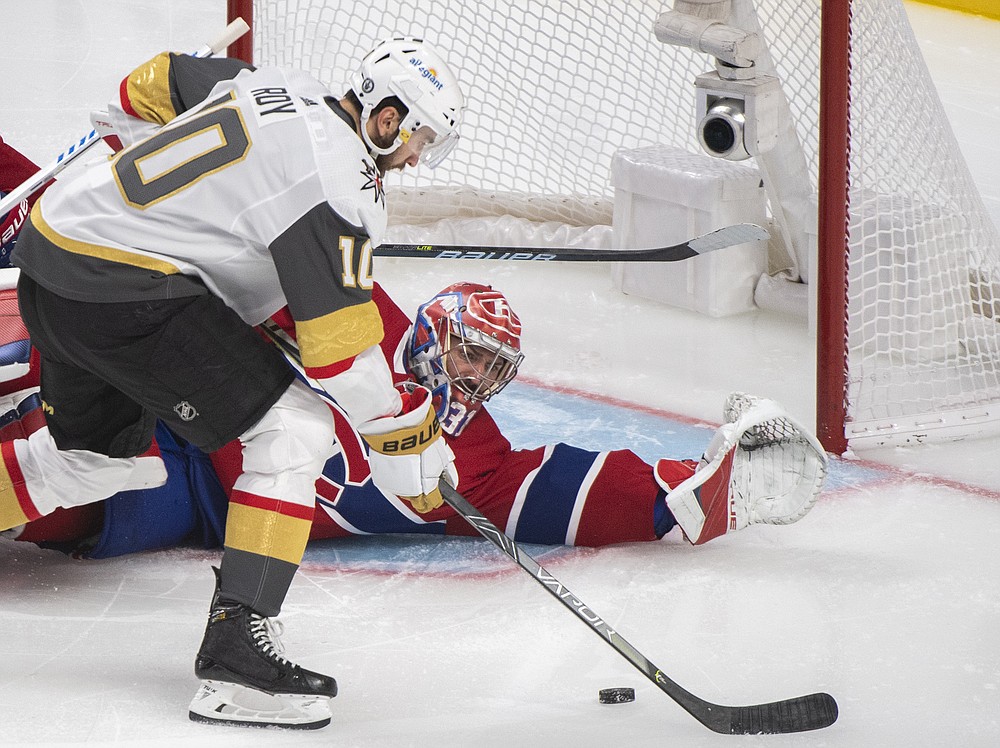 Vegas Golden Knights' Nicolas Roy scores against Montreal Canadiens goaltender Carey Price during overtime of Game 4 in an NHL Stanley Cup playoff hockey semifinal in Montreal, Sunday, June 20, 2021. (Graham Hughes/The Canadian Press via AP)