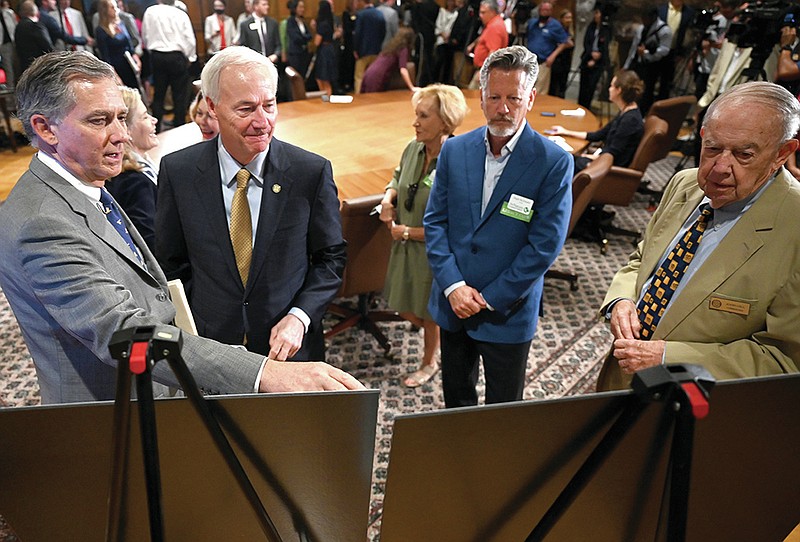 (From left) Representative French Hill, Governor Asa Hutchinson, Hugh McDonald from the Nature Conservancy, and John Gill from the Arkansas Parks and Recreation Foundation look over photos from the Lake Sylvia Recreation Area on display before the start of a press conference where Governor Hutchinson announced a new Arkansas Office of Outdoor Recreation, which will exist under the leadership of Secretary Stacy Hurst and in the Arkansas Department of Parks, Heritage and Tourism on Monday, June 21, 2021. See more photos at arkansasonline.com/622gov/

(Arkansas Democrat-Gazette/Stephen Swofford)