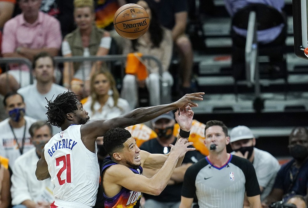 Los Angeles Clippers guard Patrick Beverley (21) fouls Phoenix Suns guard Devin Booker, front right, as the two battle for a rebound during the first half of Game 1 of the NBA basketball Western Conference finals Sunday, June 20, 2021, in Phoenix. (AP Photo/Ross D. Franklin)