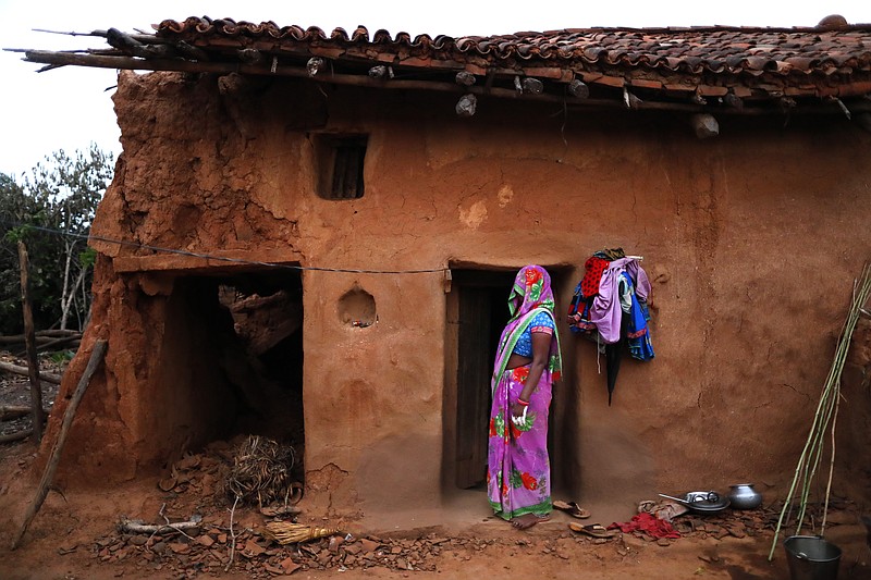 A woman watches health workers leaving, standing in front of her house at Jamsoti village, in Chandauli district, Uttar Pradesh state, India, on June 8, 2021. India's vaccination efforts are being undermined by widespread hesitancy and fear of the jabs, fueled by misinformation and mistrust. That's especially true in rural India, where two-thirds of the country’s nearly 1.4 billion people live. (AP Photo/Rajesh Kumar Singh)