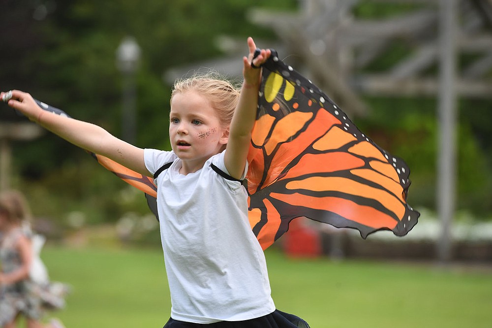Evie East, 5, catches air under her wings Tuesday July 14, 2020 at the Botanical Garden of the Ozarks in Fayetteville. In place of the Firefly Fling Festival, which was canceled due to covid-19, the garden is hosting Magical Evenings in the Garden during the week of July 12 - 18. The garden will be open from 6:30 to 8:30 pm. Guests are invited to wear their fairy wings or costumes, bring picnics, and enjoy the garden in the cool of the evening. In order to allow proper social distancing, guest capacity will be limited. Face coverings will be required and guests must maintain a minimum of six feet from others.. To reserve space visit the garden's website at www.bgozarks.org. Evie was at the garden with her parents Cash and Bright East of Fayetteville. Visit nwaonline.com/200715Daily/ for photo galleries. (NWA Democrat-Gazette/J.T. Wampler)