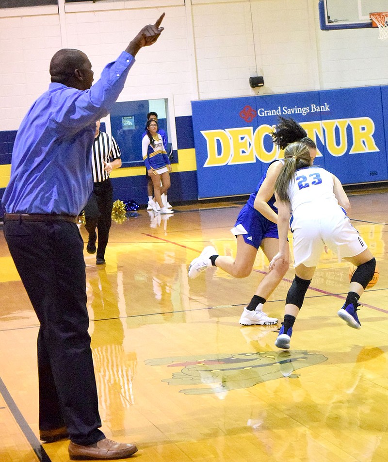 Westside Eagle Observer/MIKE ECKELS

Fess Thompson (left) points to the basket as Abby Tilley (23) and a Lady Rocket player fight for possession of a loose ball during the November 14, 2019 Decatur-Future School of Fort Smith game at Peterson Gym in Decatur. Thompson returns to the Lady Bulldog program after coaching at Pine Bluff last season.