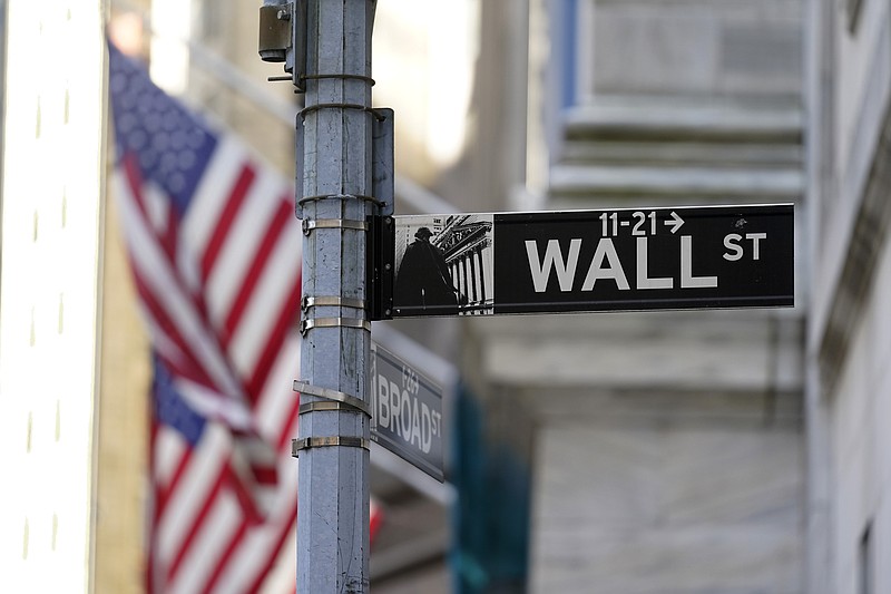 Flags adorn the facade of the New York Stock Exchange, Wednesday, June 16, 2021. Stocks are opening mostly lower on Wall Street Tuesday, June 22 as traders wait for more clues on the Federal Reserve's thinking on inflation.  (AP Photo/Richard Drew)