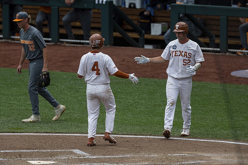 Texas Silas Ardoin (4) scored on a single in the fourth inning against Tennessee  during an NCAA college baseball game in the College World Series Tuesday, June 22, 2021, at TD Ameritrade Park in Omaha, Neb. (AP Photo/John Peterson)