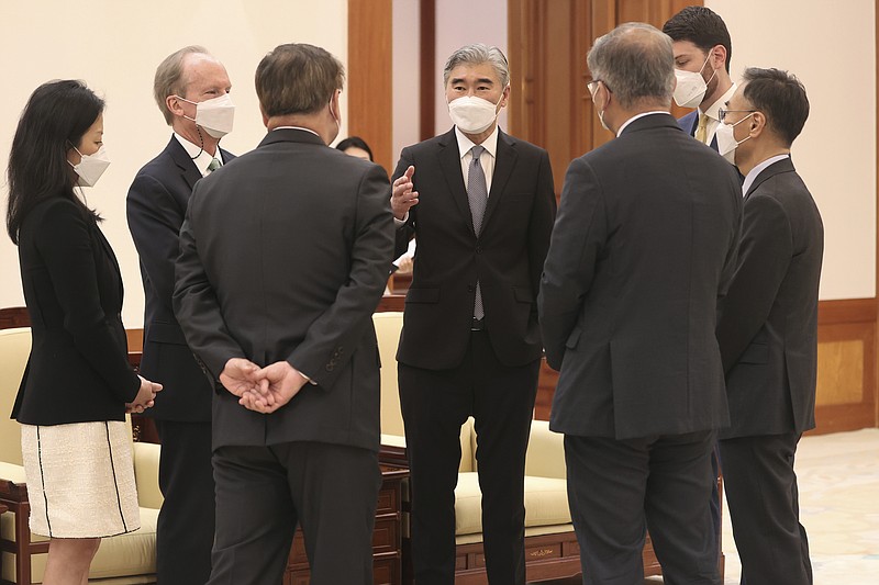 U.S. Special Representative for North Korea, Sung Kim, center, talks with South Korean and U.S. officials prior to a meeting with South Korean President Moon Jae-in at the presidential Blue House in Seoul, South Korea, Tuesday, June 22, 2021. Kim Yo Jong, the powerful sister of North Korean leader Kim Jong Un, dismissed prospects for early resumption of diplomacy with the United States, saying Tuesday the U.S. expectations for talks would "plunge them into a greater disappointment. (Choe Jae-koo/Yonhap via AP)