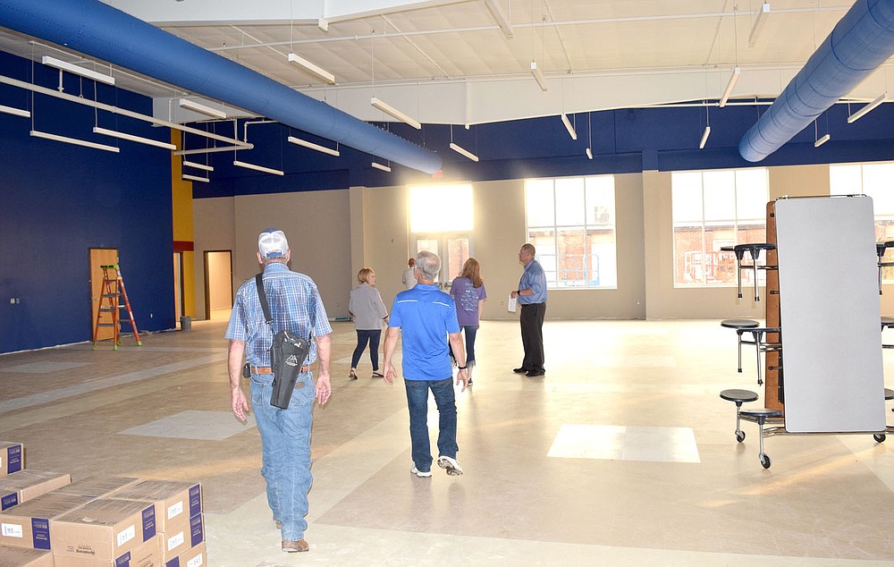Westside Eagle Observer / MIKE ECKELS Members of the Decatur School Board examine the nearly full cafeteria at Decatur High School on June 10.  Only a few electrical, painting and tiling problems remain to be completed.  The project will be ready to receive its first students on the opening day of classes on August 18.