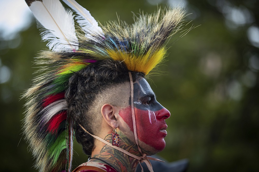 Zachary Orchard of Shoal Lake 40 First Nation on the Manitoba-Ontario border listens during a ceremony and vigil to the 215 children whose remains were found buried in the former Kamloops Indian Residential School in Vancouver, British Columbia, on National Indigenous Peoples Day , Monday, June 21, 2021. (Darryl Dyck / The Canadian Press via AP)