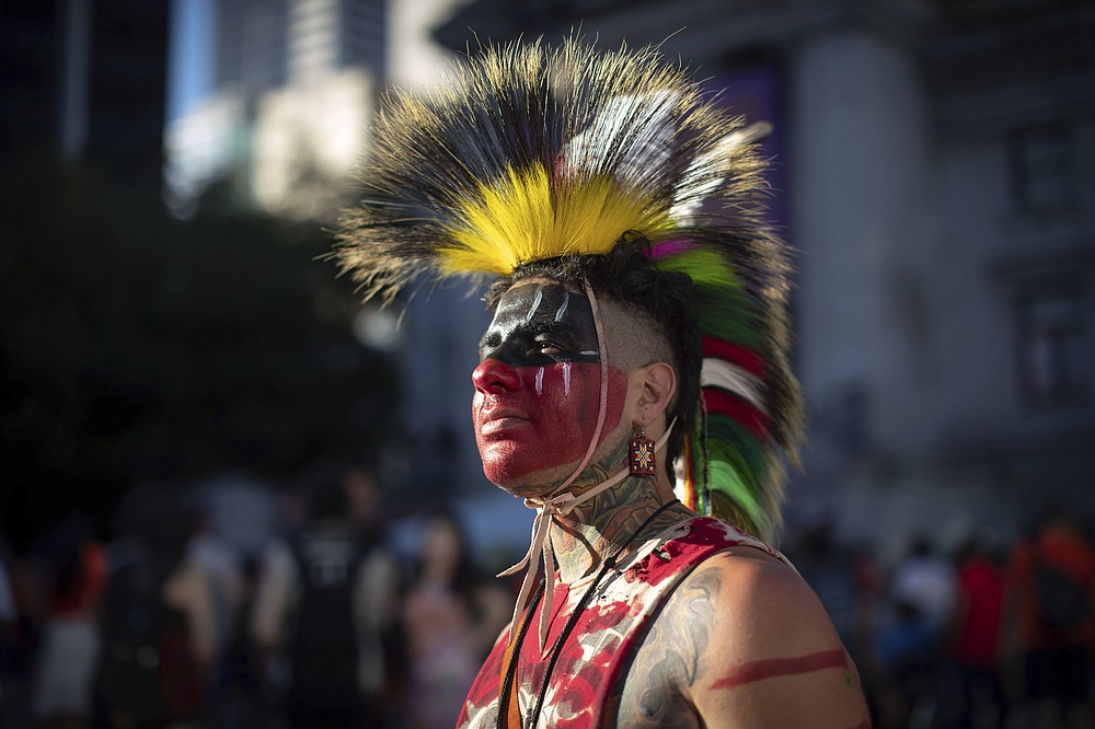 Zachary Orchard of Shoal Lake 40 First Nation on the Manitoba-Ontario border poses for a photo as he participates in a ceremony and vigil for the 215 children whose remains are buried at the former Kamloops Indian Residential School in Vancouver, British Columbia were found.  on National Indigenous Peoples Day, Monday, June 21, 2021. (Darryl Dyck / The Canadian Press via AP)