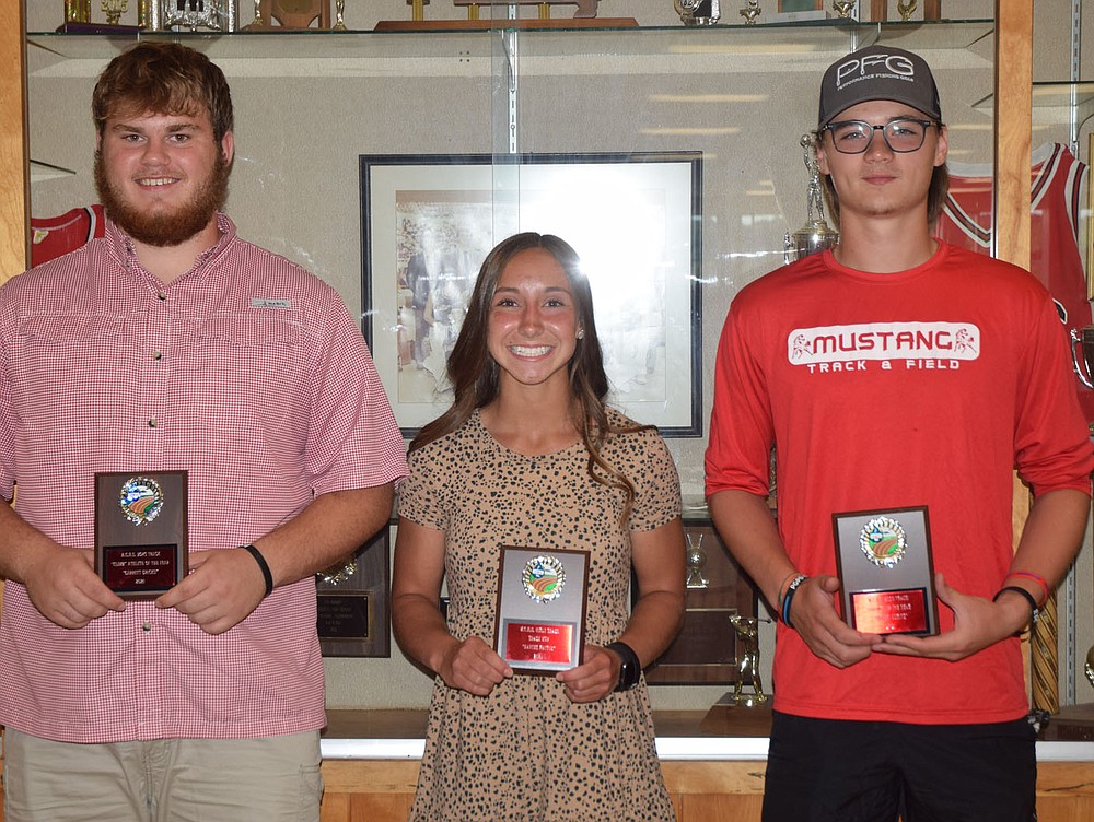 RICK PECK/SPECIAL TO MCDONALD COUNTY PRESS
McDonald County High School track coaches Chris Kane and Ashleigh McFarland presented team awards for the 2021 season at an athletic banquet held on June 22 at MCHS. From left to right: Garrett Gricks, "Climb" Athlete of the Year; Kaycee Factor, MVP; and Andrew Moritz, Thrower of the Year. Boys' winners not present: Hunter Leach, Runner of the Year; Josh Pacheco, Jumper of the Year; Junior Eliam, Newcomer of the Year; and, Kaidan Campbell and J.J. Cisneros, four-year commitment. Girls' winners not present: Sosha Howard, Jumps MVP; Mariana Salas, Throws MVP; and, Anna Belle Price and Gissele Reyes, "Climb" Athletes of the Year.
