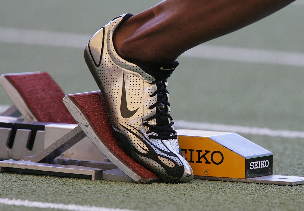 FILE - A Nike running shoe is seen in the starting block during the IAAF Athletics World Final in Stuttgart, southern Germany, in this Saturday, Sept 9, 2006, file photo. Ever since a track coach named Bill Bowerman tinkered with the idea of pouring rubber into his waffle iron to concoct a better shoe sole for running, Nike and track have grown together. (AP Photo/Daniel Maurer, File)