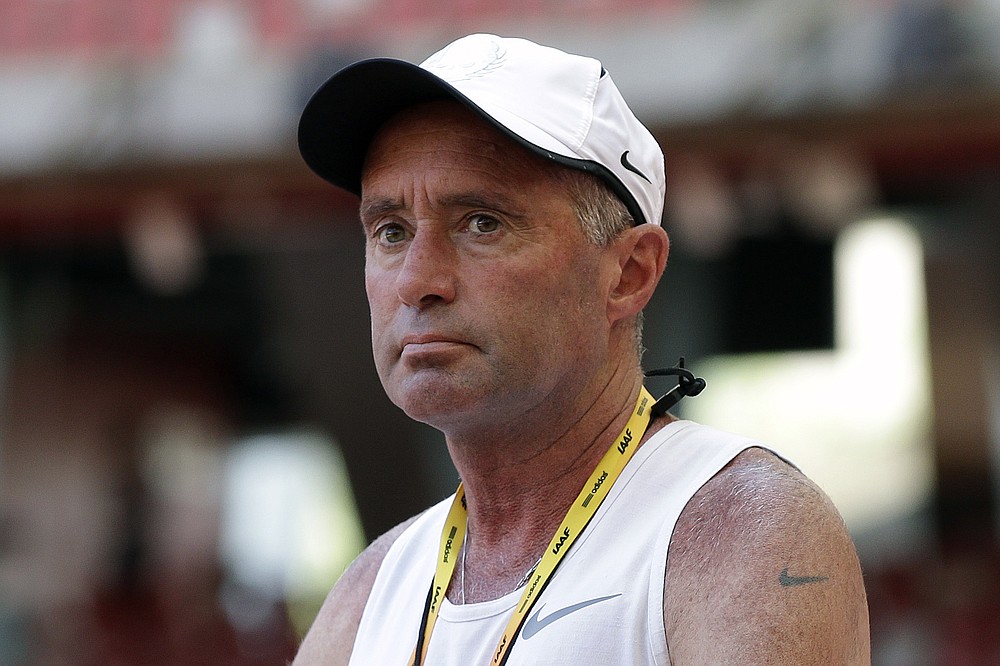 FILE - In this Aug. 21, 2015, file photo, Alberto Salazar watches a training session for the World Athletic Championships at the Bird's Nest stadium in Beijing. Though frequently scrutinized the way any market leader is, Nike’s stranglehold on track and field has been tested over the past few years — if not in a pure dollar-for-dollar sense, then certainly in the way it is perceived by its most fervent followers. A sordid doping case involving Nike’s most high-profile coach, Alberto Salazar, continues to play out this summer at the Court of Arbitration for Sport. (AP Photo/Kin Cheung, File)