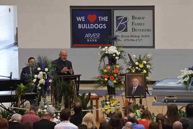 Ronnie Deal, lead pastor of Greenwood First Baptist Church, speaks about Aaron Gamble during the funeral service for both him and his son, Landry Gamble, at H.B. Stewart Bulldog Arena at Greenwood High School Wednesday.
(NWA Democrat-Gazette/Thomas Saccente)