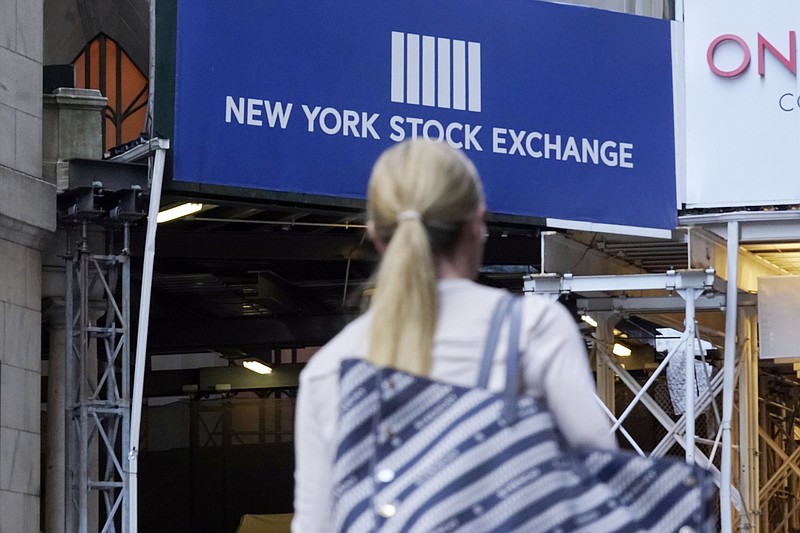 A woman passes an entrance of the New York Stock Exchange, Wednesday, June 16, 2021. Stocks are opening higher on Wall Street, continuing an upturn this week that has brought the S&P 500 back to the record high level it reached a week and a half ago. The benchmark index was up 0.6% in the early going Thursday, June 24. (AP Photo/Richard Drew)