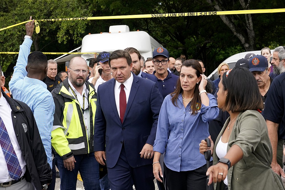 Florida Governor Ron DeSantis, center left, and Lt. Gov. Jeanette Nunez, center right, arrive for a press conference near the stage where a wing of a 12-story oceanfront building s 'collapsed on Thursday, June 24, 2021, in the Miami Surf Zone.  (AP Photo / Lynne Sladky)