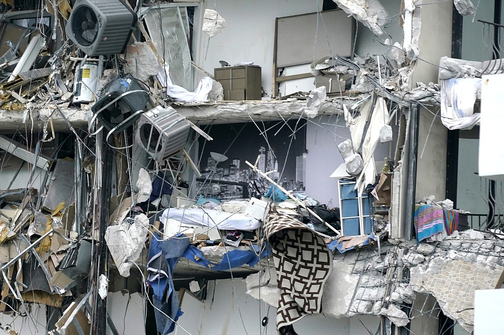 Housewares and debris hang from a partially collapsed multi-story oceanfront condo on Thursday, June 24, 2021, in Surfside, Fla. (AP Photo / Wilfredo Lee)