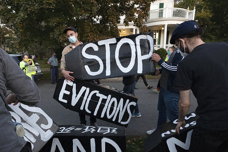 In this Oct. 14, 2020, file photo, housing activists erect a sign in Swampscott, Mass. A federal freeze on most evictions is set to expire soon. The moratorium, put in place by the Centers for Disease Control and Prevention in September, was the only tool keeping millions of tenants in their homes. - AP Photo/Michael Dwyer