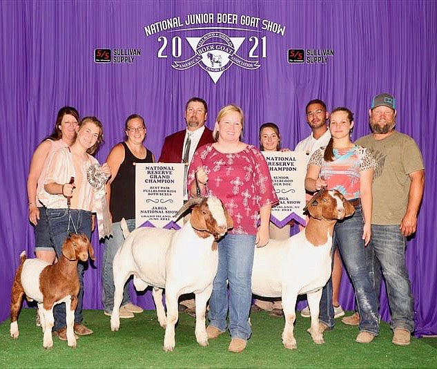 Submitted Photos 
Members of the Corey Taylor family and their supporters pose on the platform at the National Junior Boer Goat Show. They are pictured with their goats CDAF Bodacious, CTDT Show Me Dancings Happy Tide and Shoe Me Boers Dancing Queen and the banners they won in competition at the show.