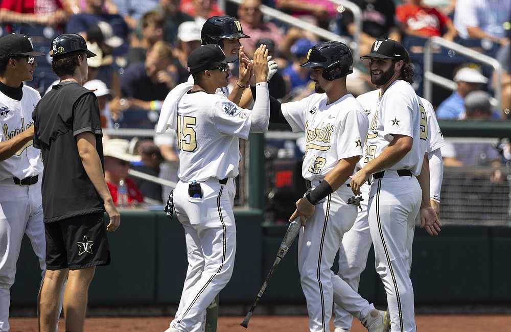 Vanderbilt's Dominic Keegan (12) celebrates with teammates as he returns to the dugout after being batted in off a single by CJ Rodriguez in the fourth inning during a baseball game against North Carolina State in the College World Series, Friday, June 25, 2021, at TD Ameritrade Park in Omaha, Neb. (AP Photo/Rebecca S. Gratz)