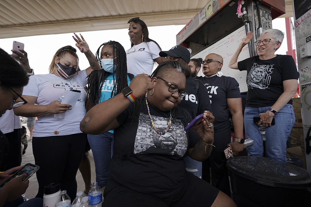 Jennifer Starr Dodd, center, and other supporters react to the sentencing of former Minneapolis police Officer Derek Chauvin for the murder of George Floyd, Friday, June 25, 2021, at George Floyd Square where Floyd was killed, in Minneapolis. Chauvin was sentenced to 22 1/2 years in prison.  (AP Photo/Julio Cortez)