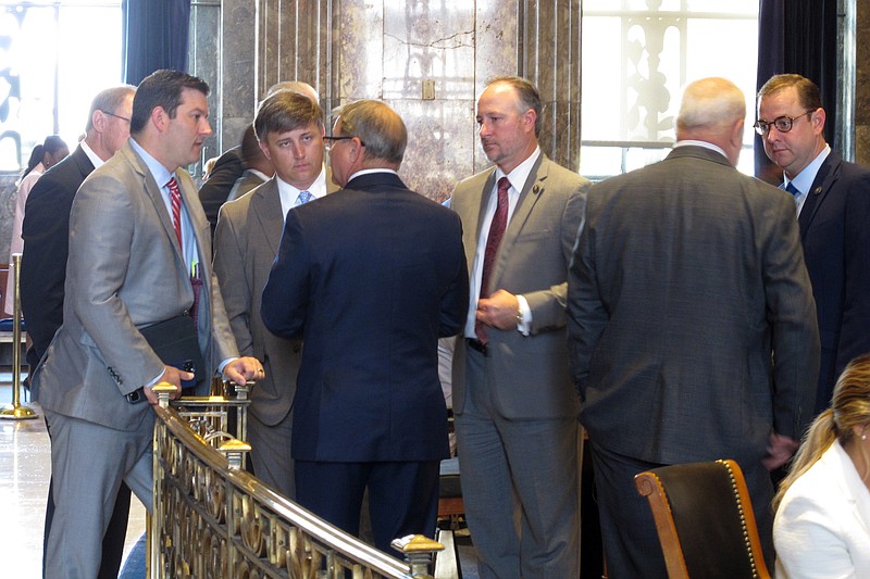 Louisiana state senators surround Senate President Page Cortez, R-Lafayette, third from the left, to talk through the remaining financial deals awaiting votes on the legislative session, June 10, in Baton Rouge, La. - AP Photo/Melinda Deslatte