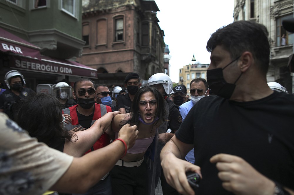 Police arrest activists who attempted to hold a pride event in central Istanbul on Saturday, June 26, 2021. Police used tear gas and rubber bullets to disperse the crowd and arrested dozens of LGTBI activists as hundreds defied a ban and attempted to organize a gay pride event.  (AP Photo / Emrah Gurel)