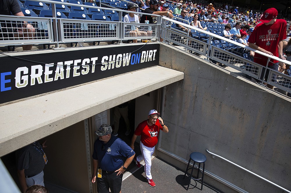 North Carolina State head Coach Elliott Avent exits the locker room during a delay due to COVID-19 safety protocols before their baseball game against Vanderbilt at the College World Series Friday, June 25, 2021, at TD Ameritrade Park in Omaha, Neb. (AP Photo/Rebecca S. Gratz)