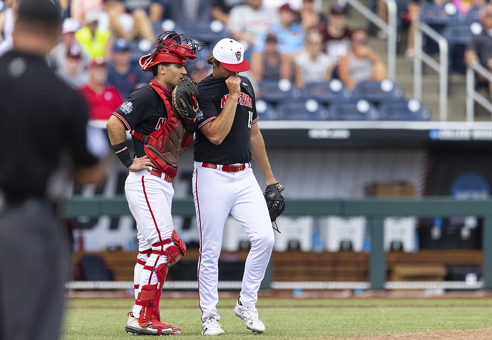 North Carolina State catcher Luca Tresh, left, talks with pitcher Dalton Feeney in the sixth inning during a baseball game against Vanderbilt in the College World Series, Friday, June 25, 2021, at TD Ameritrade Park in Omaha, Neb. (AP Photo/Rebecca S. Gratz)