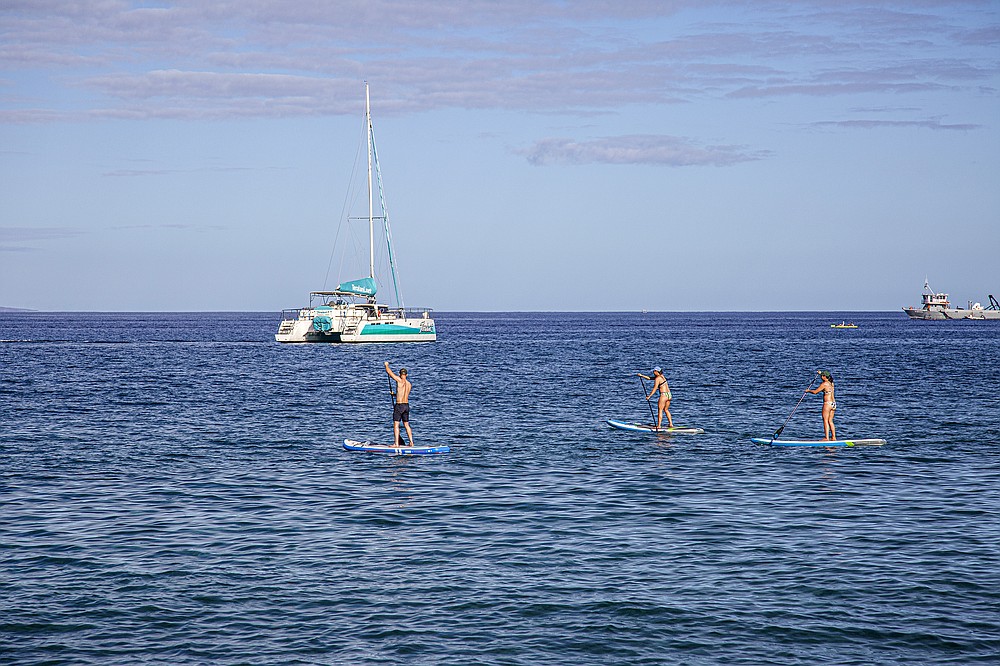 Paddleboarders stay close to the shore on Maui. (Photo for The Washington Post/Ryan Siphers)