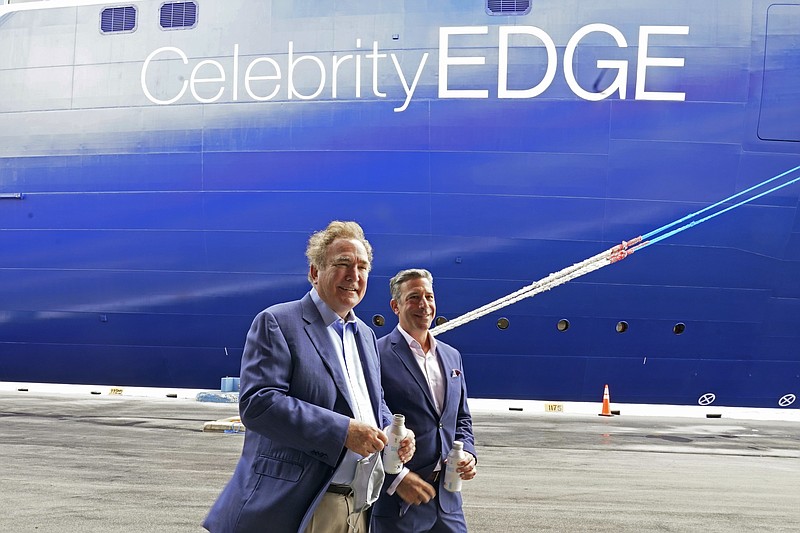 Richard Fain, Chairman and CEO of Royal Caribbean Group, left and Brian Abel, Senior Vice President of Hotel Operations and Celebrity Cruises walk next to the Celebrity Edge, Saturday, June 26, 2021, in Fort Lauderdale, Fla. The first cruise ship is preparing to leave a U.S. port since the coronavirus pandemic brought the industry to a 15-month standstill. Celebrity Edge will depart with the number of passengers limited to 40 percent capacity, and with virtually all passengers vaccinated against COVID-19. (AP Photo/Marta Lavandier)