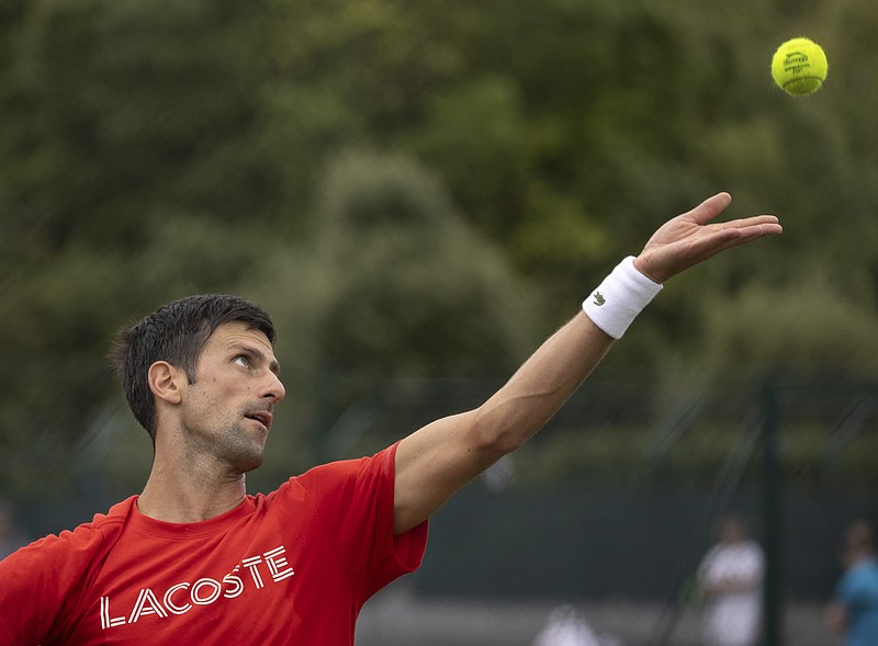 Serbia'a Novak Djokovic serves, during his practice match, prior to the Wimbledon Tennis Championships in London, Saturday June 26, 2021. (David Gray/Pool via AP)