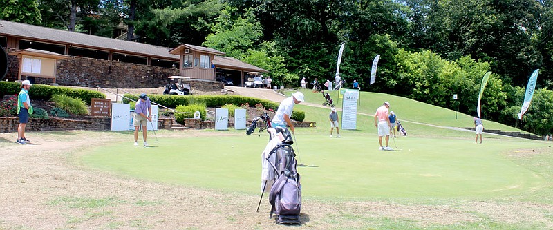 Keith Bryant/The Weekly Vista
Golfers practice on the putting green at the Country Club Golf Course during the APT Tour's Bella Vista tournament last week.