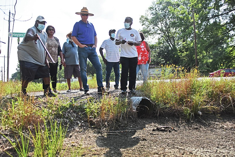 Kristina Gulley (second from left), Justice of the Peace for District 10, and Aaron Robinson (center), JOP for District 11, listens to their constituents Thursday, June 24, 2021 as they talk about a ditch that floods due to blocked culverts along Highway 161 in North Little Rock.
(Arkansas Democrat-Gazette/Staci Vandagriff)