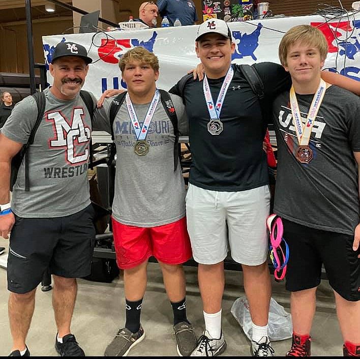 PHOTO SUBMITTED McDonald County High School wrestling coach Josh Factor (left) will take three wrestlers to the freestyle and Greco-Roman national championships to be held July 16-23 in Fargo, N.D. From left to right are Factor, Samuel Murphy, Jayce Hitt and Alex Bogart.