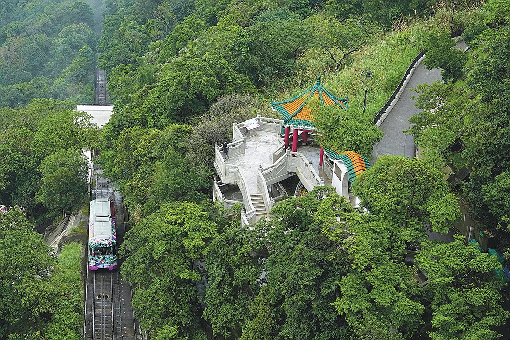 A Peak Tram passes upstream from Victoria Peak in Hong Kong on June 17, 2021. The Hong Kong Peak Tram is a staple in the memory of many residents and tourists, carrying passengers to Victoria Peak for a bird's-eye view of the many city skyscrapers. (AP Photo / Vincent Yu)