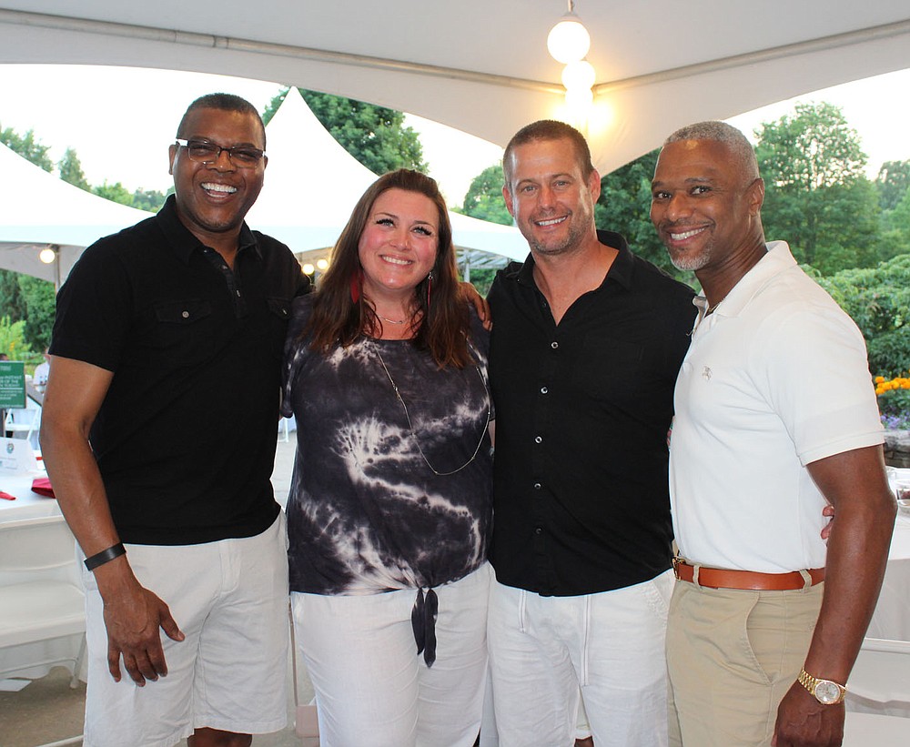 Jerry Jackson (from left), Kristin and Lee Evans and Marcus Pinkey attend Red, White and Baby Blue.
(NWA Democrat-Gazette/Carin Schoppmeyer)