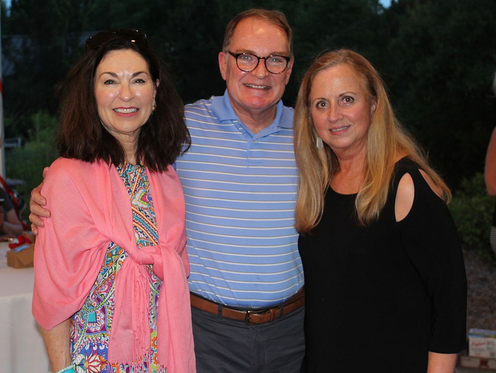 Kathryn and Bill Warren (from left) visit with Debbie Ogg at Red, White and Baby Blue.
(NWA Democrat-Gazette/Carin Schoppmeyer)