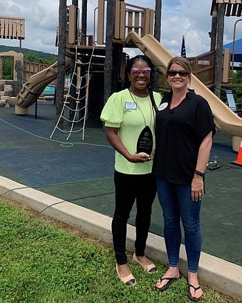 Monique Jones, Rotary Club of Fayetteville 2021 Clark McClinton Award recipient, stands with Kelly Gemmell, Service Above Self committee member, at the organization’s 100th anniversary and Service Above Self Picnic June 5 at Rotary Playground at Mount Kessler in Fayetteville.