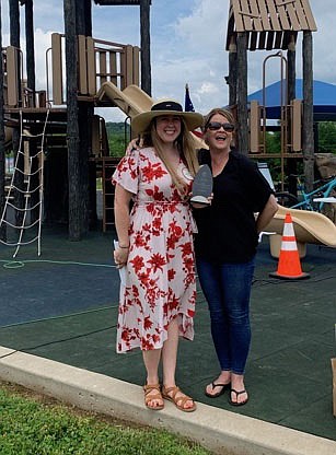 Zoe Naylor (left), Rotary Club of Fayetteville for 2020-21, is presented an honorary Service Above Self award by Kelly Gemmell, Service Above Self committee member, at the group’s 100th anniversary and Service Above Self Picnic June 5.