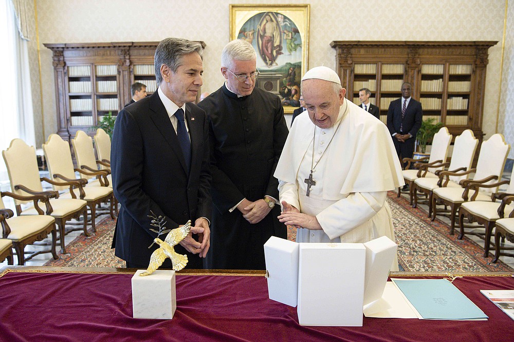 Pope Francis exchanges gifts with Secretary of State Antony Blinken as they meet in the Vatican on Monday, June 28, 2021. Blinken is on a week-long trip to Europe in Germany, France and Italy.  (Vatican Media via AP Photo)