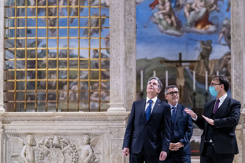 Secretary of State Antony Blinken, left, accompanied by guide Alessandro Conforti, right, and Chargé d'Affaires of the United States Embassy to the Holy See Patrick Connell, second from left, visits the Sistine Chapel at the Vatican in Rome, Monday June 28, 2021. Blinken is on a weeklong trip to Europe in Germany, France and Italy.  (AP Photo / Andrew Harnik, Pool)