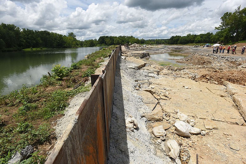 The main channel of the Illinois River is seen Tuesday June 29 2021 on the left of a steel barrier while the channel that will be the whitewater park is at right. Go to nwaonline.com/210629Daily/to see more photos.
(NWA Democrat-Gazette/Flip Putthoff