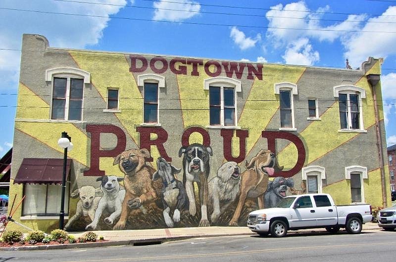 Kevin Kresse painted the two-story “Dogtown Proud” mural at 400 Main St. (Special to the Democrat-Gazette/Marcia Schnedler)