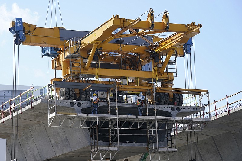 A construction crew work on a new segment of the I-395 interstate highway, Thursday, May 6, 2021, in Miami.  U.S. construction spending fell 0.3% in May with housing activity slowing and nonresidential construction falling.   (AP Photo/Marta Lavandier)