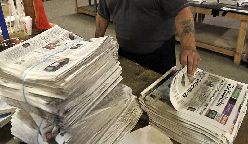 FILE - An employee sorts newspapers for delivery at a distribution center in Liberty Township near Youngstown, Ohio, on Aug. 6, 2019. Pew Research Center data released this week showed that 2020 was the first year that the newspaper industry earned more money from circulation than advertising, (AP Photo/Tony Dejak, File)
