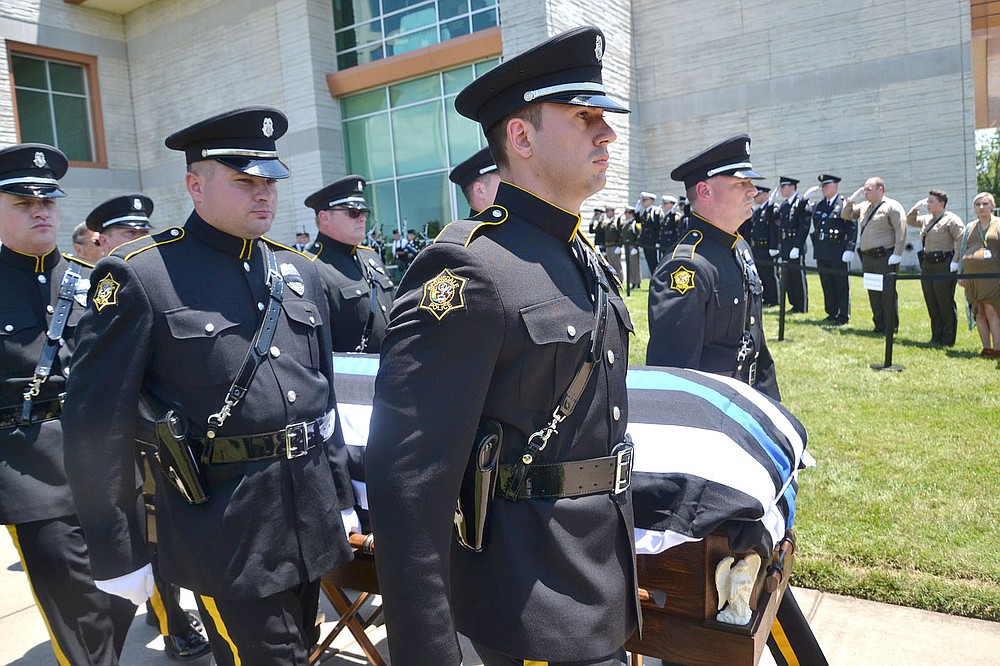 Members of an honor guard escorted the coffin of Pea Ridge Police Officer Kevin Apple from the church to the waiting hearse Friday, July 2.