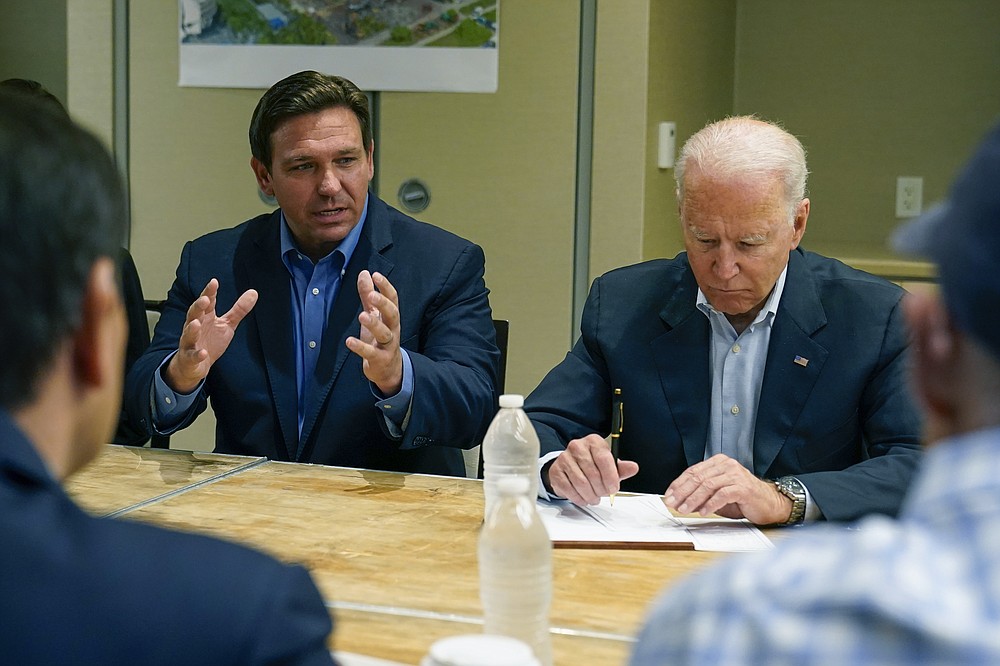 President Joe Biden listens as Florida Gov. Ron DeSantis speaks during a briefing in Miami Beach, Fla., Thursday, July 1, 2021, about the collapsed condo tower in Surfside. (AP Photo/Susan Walsh)