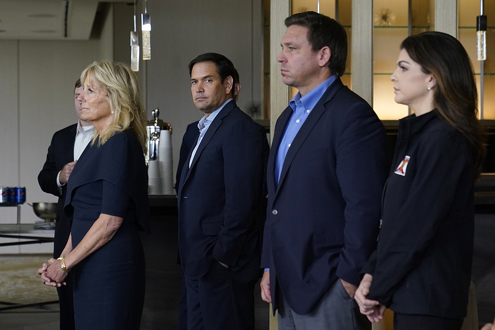 First lady Jill Biden, left, Sen. Marco Rubio, R-Fla., Florida Gov. Ron DeSantis and his wife Casey DeSantis, listen as President Joe Biden meets with first responders in Miami Beach, Fla., Thursday, July 1, 2021, who were working on the condo tower that collapsed in Surfside, Fla., last week. (AP Photo/Susan Walsh)