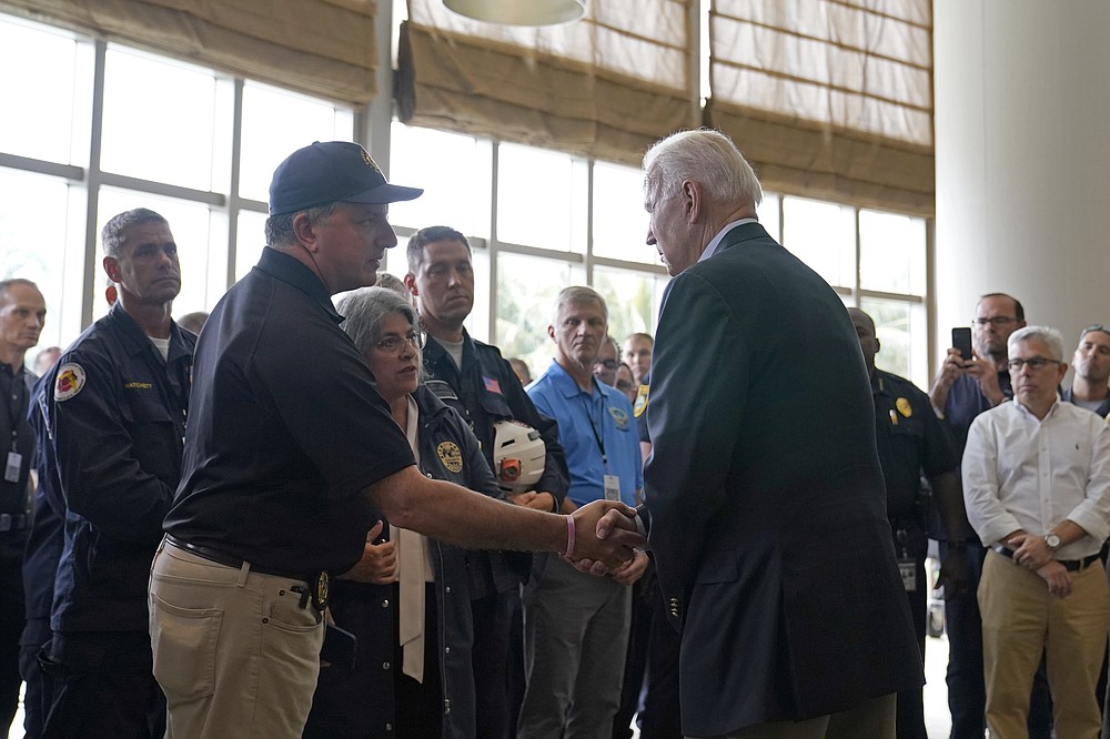 President Joe Biden shakes hands with Florida Chief Financial Officer and State Fire Marshal Jimmy Patronis during a meeting with first responders in Miami Beach, Fla., Thursday, July 1, 2021, who were working on the condo tower that collapsed in Surfside, Fla., last week. (AP Photo/Susan Walsh)