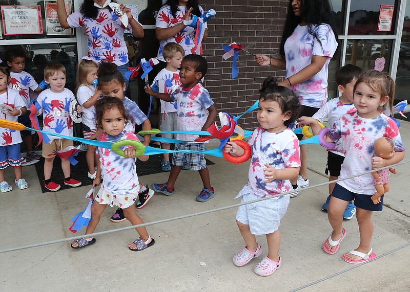 Students participate in the annual Fourth of July parade at Hot Springs Child Care Center on Main Street Friday. - Photo by Richard Rasmussen of The Sentinel-Record